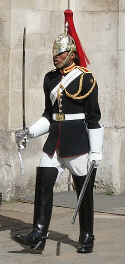 A lance corporal of the Blues and Royals in full dress, distinguished by basic aiguillettes and no shoulder cords
