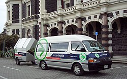 A shuttle van service to Dunedin International Airport picks up a passenger at Dunedin Railway Station in New Zealand.