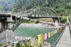 Modern and traditional bridges over a river in Panbang