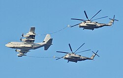 A USMC KC-130 Hercules refuels a pair of USMC CH-53E Super Stallions, 2011