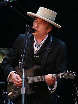 Dylan playing guitar onstage