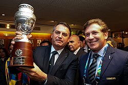 Brazilian president Jair Bolsonaro lifts the Copa América replica trophy.