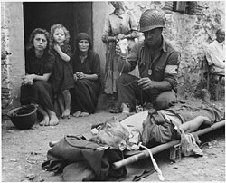 Wounded soldier being given blood plasma in Sicily, 1943
