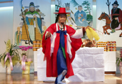 A person in red clothing performing a ritual