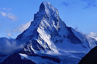 Compressed metamorphosed Tethyan sediments and their oceanic basement are sandwiched between the tip of the Matterhorn (Italian-Swiss border), which consists of gneisses originally part of the African plate, and the base of the peak, which is part of the Eurasian plate.[57]