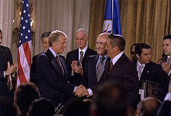 Carter and Omar Torrijos shake hands moments after the signing of the Torrijos-Carter Treaties.