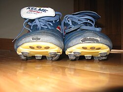 Football boots with moulded studs at the bottom