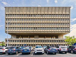 Western elevation of the facade, with a parking lot in front