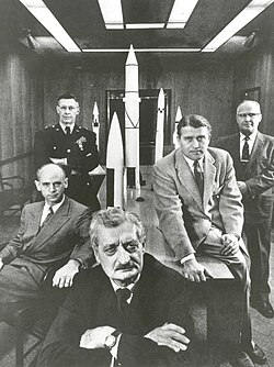 Hermann Oberth (forefront) with officials of the Army Ballistic Missile Agency at Huntsville, Alabama in 1956. Left to right around Oberth: Ernst Stuhlinger (seated), Major General H. N. Toftoy, Commanding Officer responsible for "Project Paperclip", Wernher von Braun, Director, Development Operations Division, Robert Lusser, a Project Paperclip engineer.