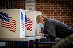 Voters cast ballots at Roosevelt High School in Des Moines, Iowa