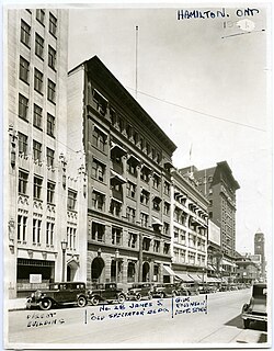 Black and white image of a downtwon street scene centered on a six-storey office building
