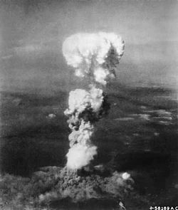White fragmentred mushroom-like smoke cloud evolving from the ground.
