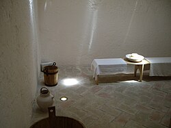 Hammam interior, showing water buckets and tilted floor (Baños del Almirante [es], Valencia)