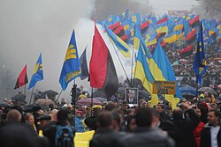 Ukrainian nationalists carry portraits of Stepan Bandera and flags of the Ukrainian Insurgent Army.