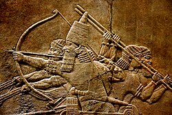 A 7th-century BC relief depicting Ashurbanipal, r. 669–631 BC, and three royal attendants in a chariot.