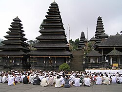 The multi-tiered Meru towers of the Besakih temple in Bali are thatched with black ijuk fibres.