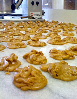 American pralines cooling on a marble slab. Unlike European pralines, American pralines are made with cream.