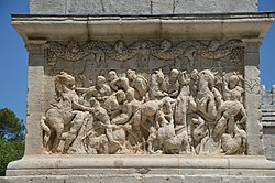 The Mausoleum of the Julii, located across the Via Domitia, to the north of, and just outside the city entrance, dates to about 40 BC, and is one of the best preserved mausoleums of the Roman era. A dedication is carved on the architrave of the building facing the old Roman road, which reads: SEX · M · L · IVLIEI · C · F · PARENTIBVS · SVEIS Sextius, Marcus and Lucius Julius, sons of Gaius, to their forebears It is believed that the mausoleum was the tomb of the mother and father of the three Julii brothers, and that the father, for military or civil service, received Roman citizenship and the privilege of bearing the name of the Julii