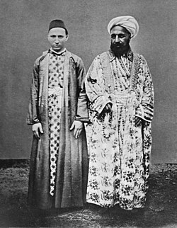A Meccan merchant (right) and his Circassian slave. Entitled, "Vornehmer Kaufmann mit seinem cirkassischen Sklaven" [Distinguished merchant and his circassian slave] by Christiaan Snouck Hurgronje, c. 1888.