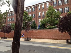 Brick wall separating Naval Square from Grays Ferry Avenue in Philadelphia