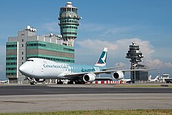 The airport control tower and a taxiing Cathay Pacific Cargo Boeing 747-8F
