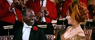 Louis Armstrong as the orchestra leader with Barbra Streisand, singing the song in the 1969 film.