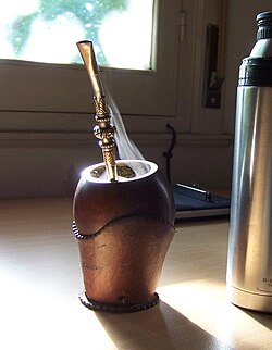 Steaming mate infusion in a cup that resembles a gourd, the customary vessel