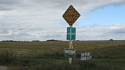 Five or more signs may be displayed on one post. Here a Canadian end-of-road marker appears together with a rural airport sign.