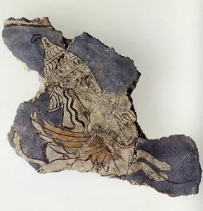 Fragment of a fresco from the Cult Center at Mycenae dating the late thirteenth century BC depicting a warrior goddess, possibly Athena, wearing a boar's tusk helmet and clutching a griffin.[11]