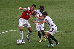 Dyer along with Neil Taylor attempt to tackle Robin van Persie