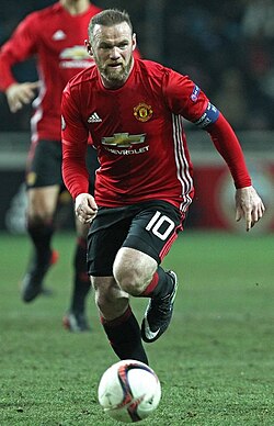 Wayne Rooney, shown wearing the number 10 jersey, was used at Manchester United as a second striker on many occasions, playing behind the number 9.[10]
