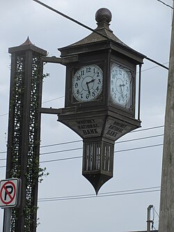 One of the long iconic clocks outside of Whitney Bank branches