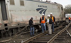 NTSB officials inspect the derailed locomotive 601