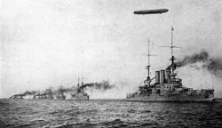 The German High Seas Fleet, with a member of the Braunschweig class in the lead, observed from above by an Imperial Navy Zeppelin conducting aerial reconnaissance