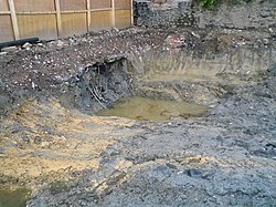 Excavation showing soil contamination at a disused gasworks in England