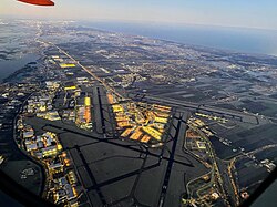 All the airport's six runways viewed from an airplane taking off at dawn