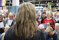 People singing together at Bella Center in Copenhagen, 2025