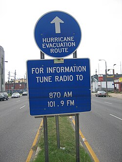 Evacuation route sign on Tulane Avenue in New Orleans shows lines from long standing floodwaters after Hurricane Katrina.