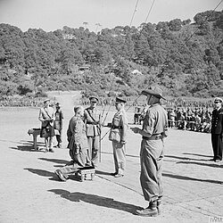 Lieutenant General Sir William Slim being knighted by the Viceroy of India, Field Marshal the Viscount Wavell, near Imphal, December 1944.