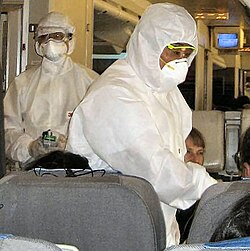 Chinese inspectors checking airline passengers for fever, a common symptom of swine flu