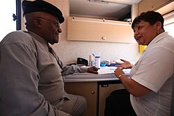 Tutu gets an HIV test on the Desmond Tutu HIV Foundation's Tutu Tester, a mobile test unit.