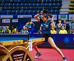 India's Manika Batra hits the ball. She specialises in playing long-pimples on her backhand, a rubber which is not often played by top players.[34]
