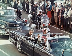 President John F. Kennedy riding in a convertible car outside of Dallas, along with his wife, Jacqueline, and others inside, minutes before he was assassinated.