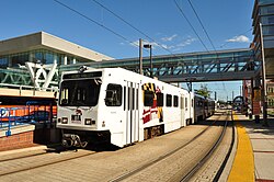 A Baltimore Light RailLink train stops at Convention Center station, just west of Baltimore Convention Center on Pratt Street.