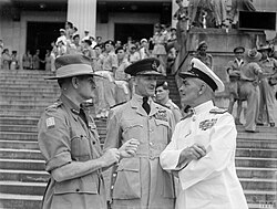 Slim with Air Marshal Sir Keith Park and Vice-Admiral Sir Arthur John Power outside Singapore's municipal building, following Japan's ceremonial surrender of the city, 12 September 1945.
