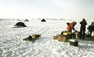 Temporary research station of German-Swiss expedition on the sea ice at the Geographic North Pole. Drillings at the landing site at 90°N showed an average ice thickness of 2.5 m (8 ft 2 in) on April 16, 1990