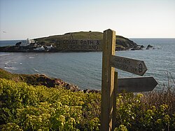 Direction sign at Bigbury-on-Sea with Burgh Island in the background