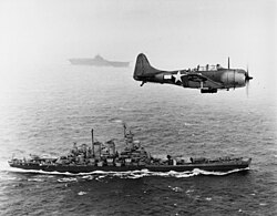 US Navy SBD-5 scout/dive bomber flying patrol over USS Washington and USS Lexington during the Gilbert and Marshall Islands campaign, 1943