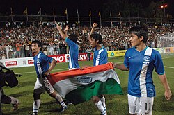 Bhaichung Bhutia and Sunil Chhetri holding the Indian National flag.