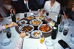 Westerners using chopsticks in a tourist restaurant in mainland China